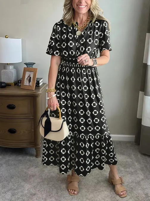 Vestido largo elegante y moderno con escote en V, cintura elástica y estampado de lunares.