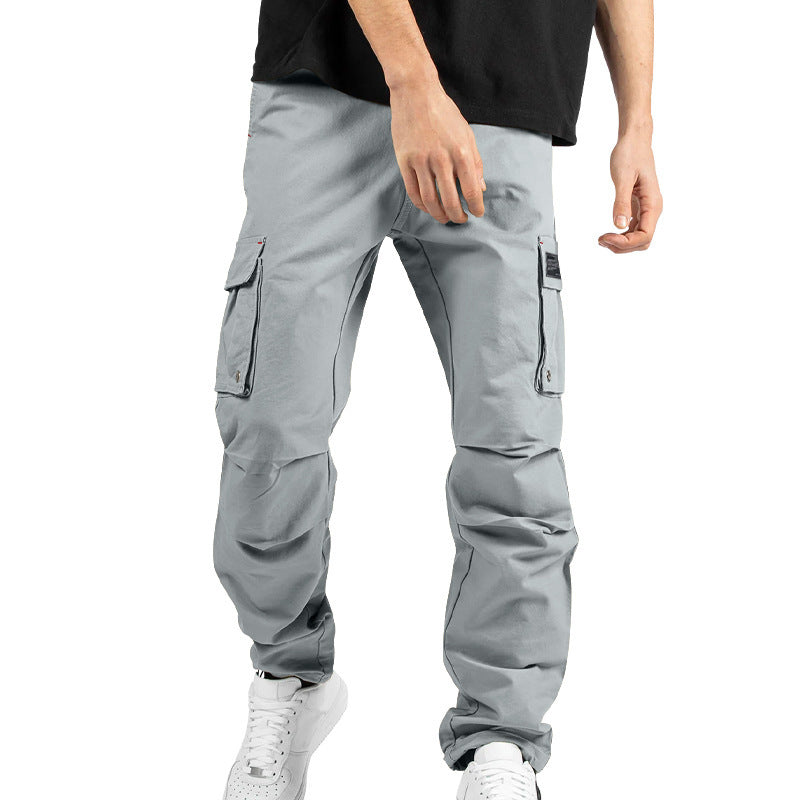 Pantalones cargo holgados de color liso con múltiples bolsillos y puños con cordón ajustable.