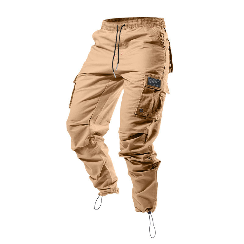 Pantalones cargo holgados de color liso con múltiples bolsillos y puños con cordón ajustable.